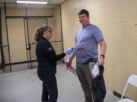 Peter Williams, a TPD volunteer playing an airplane passenger with wounds on his stomach, is on the receiving end of an air brush wielded by Deana Ann Smith, BS, BSN, RN, healthcare simulation educator for ASTEC.
