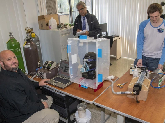 In response to the shortage of PPE, a group of researchers at the University of Arizona College of Engineering and UArizona Health Sciences worked together to design, 3D print and test masks for health care workers at Banner – University Medical Center in Tucson in April. Pictured here: Lab Manager Christopher Morton, left, Sairam Parthasarathy, MD, center, and engineering graduate student Connor Stahl.