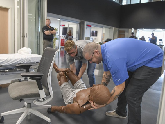 Using lifelike manikins, ASTEC personnel train staff from a local drug rehab facility to treat overdose with naloxone.