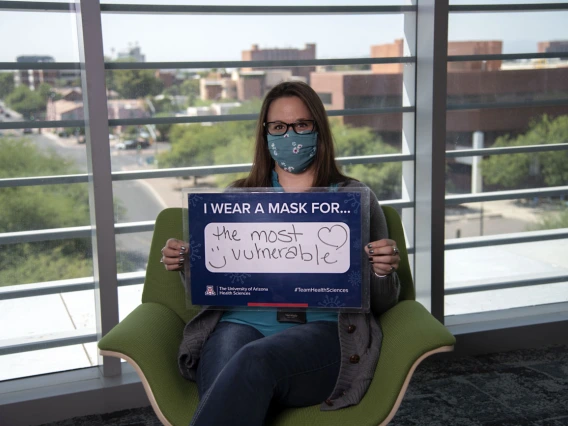 Laura Desteiguer, administrator with the UArizona Center for Innovation in Brain Science wears a mask for the most vulnerable. 