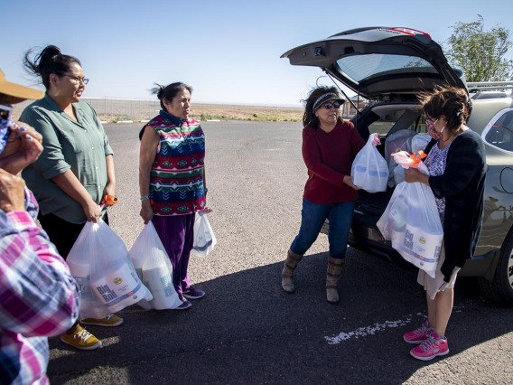 Cora Phillips hands out supplies collected from the University of Arizona Cancer Center drive to people who live in rural areas on the Navajo Nation. Phillips is a member of the Navajo Nation and serves on the Cancer Center’s Community Advisory Committee for the Partnership for Native American Cancer Prevention (NACP), an NCI-funded project at the Cancer Center. The committee consists of leaders who are working in American Indian communities.