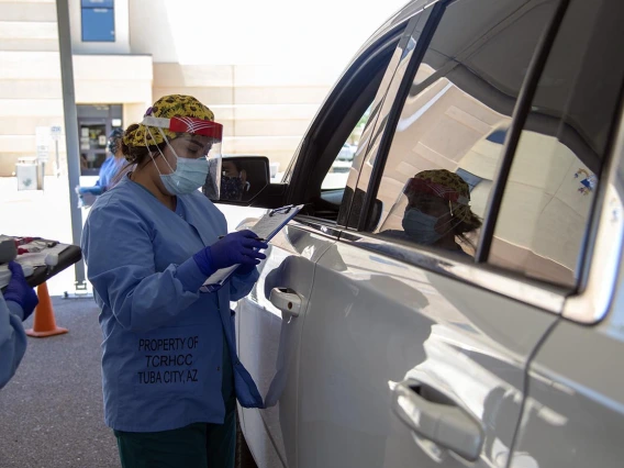 A Tuba City Regional Health Care employee speaks with a person seeking COVID-19 testing. 