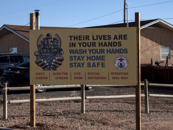 Signs and billboards are posted throughout the Navajo Nation asking tribal members to protect their family from COVID-19 by washing their hands and staying home. 
