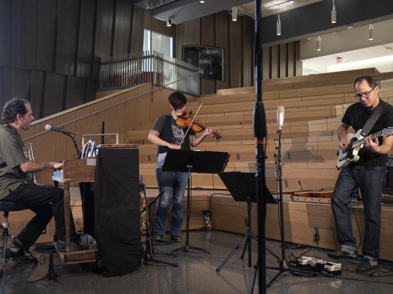 Two-Door Hatchback performs in the University of Arizona Health Sciences Innovation Building for The Tucson Studio. The band includes Samantha Bounkeua and brothers Marco (right) and Dante Rosano (left).