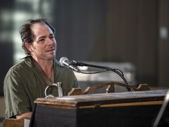 Dante Rosano of Two-Door Hatchback plays the piano during a performance in the Forum in the Health Sciences Innovation Building. 