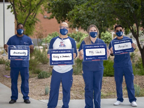 Decked out in UA Blue, from left: Aden Abdi, Philip Moya, MSN, BSN, RN, Kayla Killigrew and Nicolo Abrugena from the College of Nursing pose for the campaign. Moya is a clinical nursing instructor. Abdi, Killgrew and Abrugena are fourth-year nursing students. 