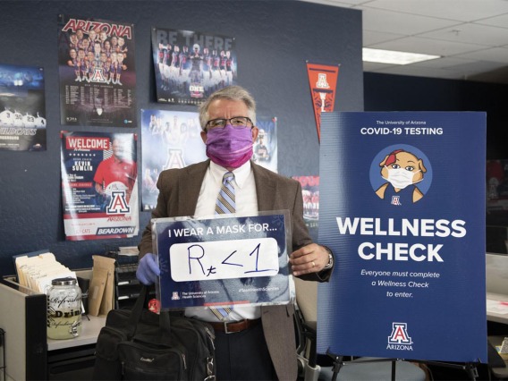 Terry Urbine, PhD, assistant professor at the University of Arizona Mel and Enid Zuckerman College of Public Health’s Phoenix campus, shares his sign, showing that wearing masks can bring the R number of the virus that causes COVID-19 below 1. This number measures the average number of people someone shedding the virus will infect.