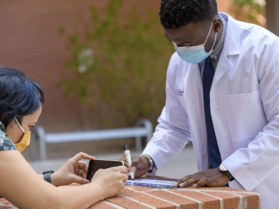 Noelle Haro-Gomez, photojournalist for the Health Sciences Office of Communications, photographs first-year College of Medicine – Tucson student Oluwatobi Faith Odeneye.