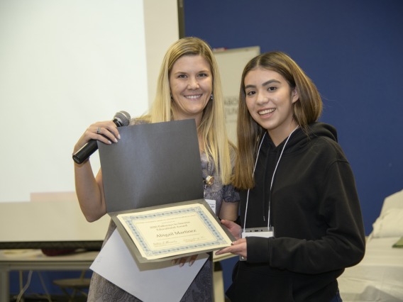 Abigail Martinez from Sunnyside High School receives a scholarship from a Banner representative.