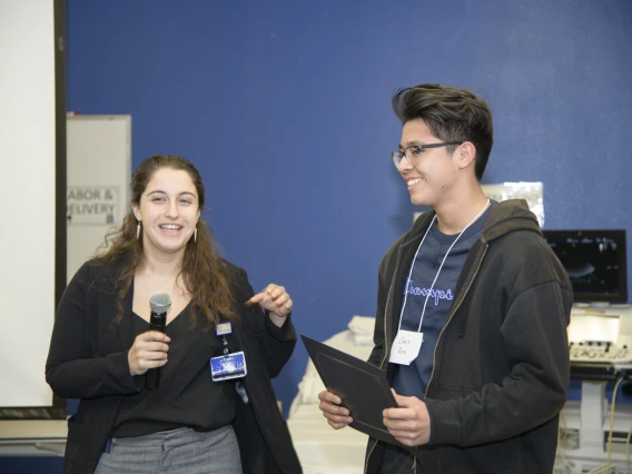 Christopher Ruiz from Sunnyside High School receives a scholarship from a Banner representative.