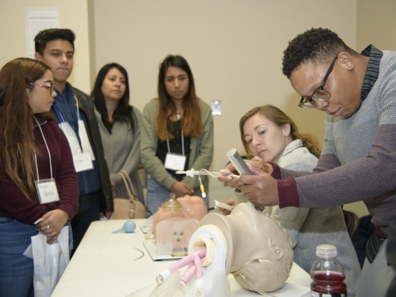 An anesthesiology specialist gives a demonstration on intubation.