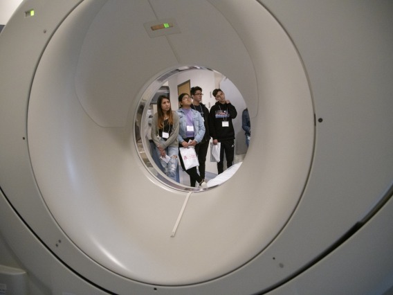 High school students touring Banner – University Medical Center South visit the CT scanner room.