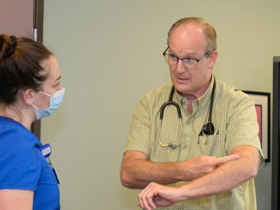 Alan Michaels and Amanda Zauner discuss patient care in the Pondersoa Family Care Rural Clinic run by Judith Hunt, MD, in Payson. 