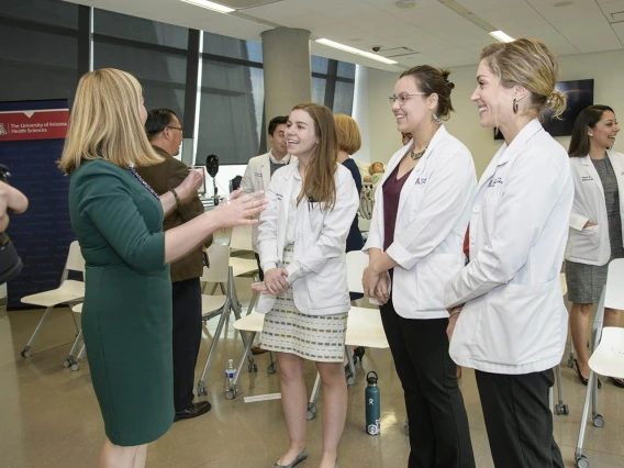 Phoenix Mayor Kate Gallego talks to Primary Care Physician scholarship recipients Merrion Dawson, Kathryn Blevins and Megan Kelly. 
