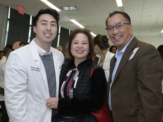 Primary Care Physician scholarship recipient George Nguyen poses for a photo with his family. 