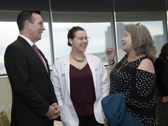 College of Medicine - Phoenix Associate Dean of Admissions and Recruitment Glen Fogerty, PhD, MBA, and Primary Care Physician scholarship recipient Kathryn Blevins talk with her family.