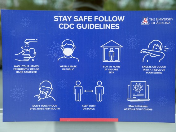 Signage reminding passersby to follow CDC safety guidelines. 