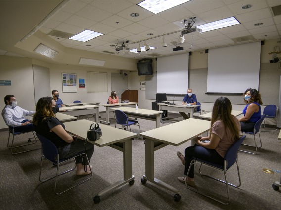 Conference rooms fit fewer people to allow for adequate physical distancing. Here, incoming first-year College of Medicine – Tucson students meet with their house dean, George Fantry, MD.