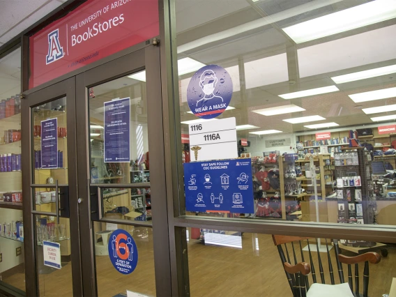 Signage outside of the UArizona Medical Bookstore encourages students to follow proper safety precautions.