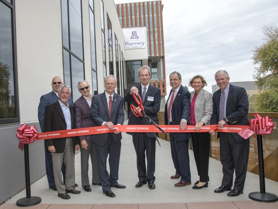 Ribbon cutting for the renovated and expanded Skaggs Center, from left to right: University of Arizona Foundation President and CEO JP Roczniak; donor Richard Katz; donor Ken Coit; UArizona College of Pharmacy Dean Rick Schnellmann, PhD; Ronny Cutshall, president of The ALSAM Foundation, which was established by the Skaggs family; UArizona Senior Vice President for Health Sciences Michael D. Dake, MD; UArizona Provost Liesl Folks, PhD, MBA; UArizona President Robert C. Robbins, MD.