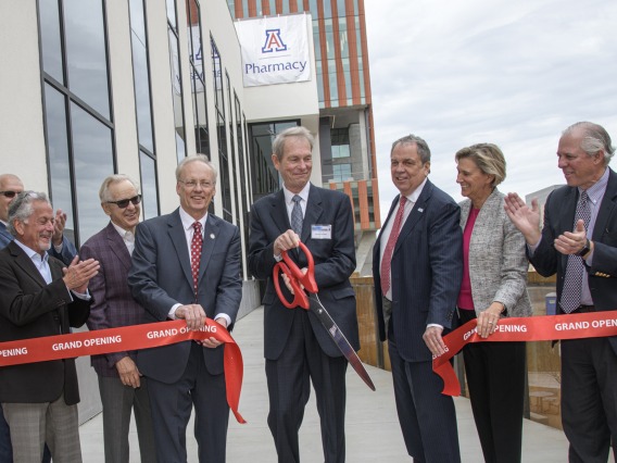 Ribbon cutting for the renovated and expanded Skaggs Center, from left to right: University of Arizona Foundation President and CEO JP Roczniak; donor Richard Katz; donor Ken Coit; UArizona College of Pharmacy Dean Rick Schnellmann, PhD; Ronny Cutshall, president of The ALSAM Foundation, which was established by the Skaggs family; UArizona Senior Vice President for Health Sciences Michael D. Dake, MD; UArizona Provost Liesl Folks, PhD, MBA; UArizona President Robert C. Robbins, MD.