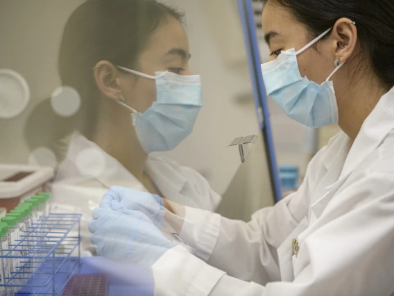 Lab technician Cindy Bujanda places a set of antigen sample tubes under a hood in the testing laboratory. Students and staff receive nasal swab results within two hours. 