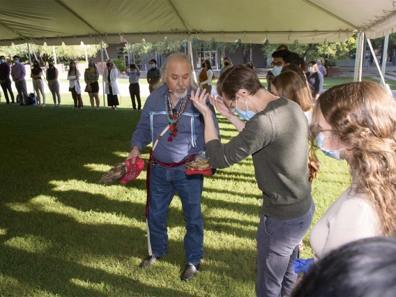 During the smudging ceremony, Dr. Carlos Gonzales blesses each individual student, faculty and staff member present. 