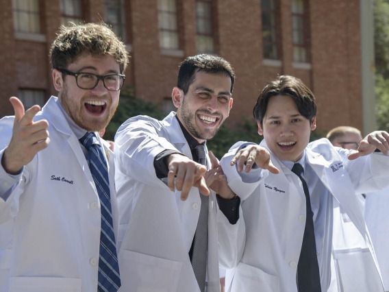 Class of 2023 R. Ken Coit College of Pharmacy students (from left) Seth Carroll, David James Caddick and Kelvin Nguyen, ham it up for a photo as they leave Centennial Hall after their white coat ceremony.