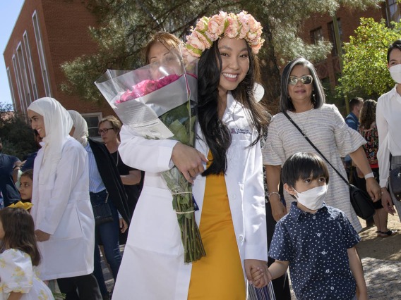 Allysa Mae Ong celebrates with her son, Arvel Zuri, after the R. Ken Coit College of Pharmacy class of 2023 white coat ceremony. 