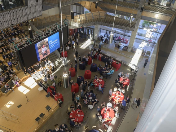 Looking down from above at the crowd gathered for the Mel Zuckerman memorial inside a large open space.