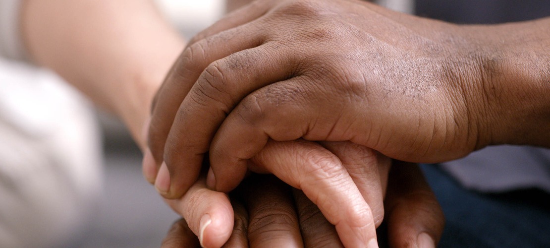 close up of two people clasping hands 