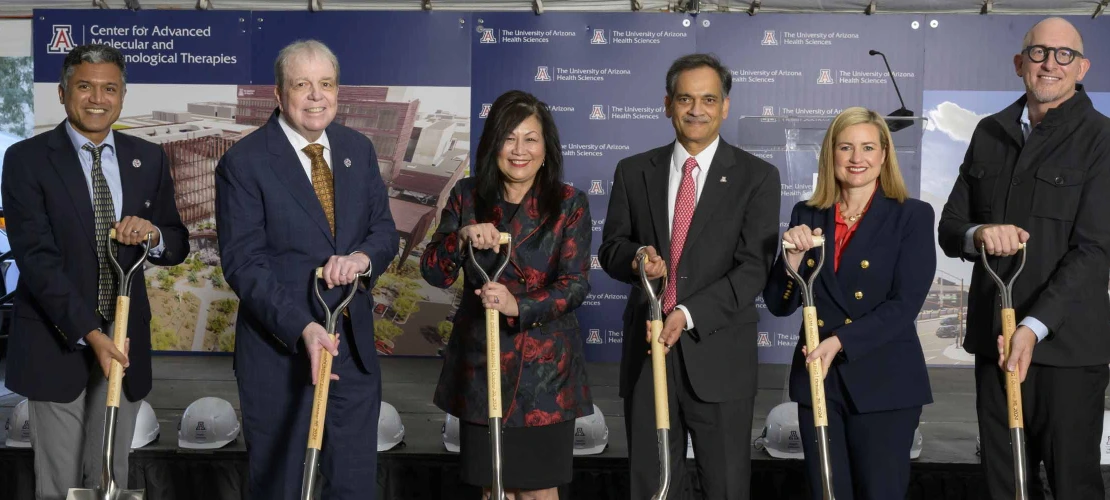 CAMI Inaugural Executive Director Deepta Bhattacharya, PhD, a professor of immunobiology at the College of Medicine – Tucson; University of Arizona Health Sciences Senior Vice President Michael D. Dake, MD; Arizona Board of Regents Chair Cecelia Mata; University of Arizona President Suresh Garimella, PhD; City of Phoenix Mayor Kate Gallego; and SmithGroup Design Director Mark Kranz, FAIA, stand side by side, holding shovels in dirt.