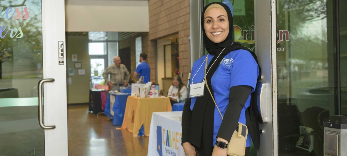 University of Arizona R. Ken Coit College of Pharmacy doctoral student Diyana Ahmad smiles for a portrait in the doorway of a health clinic in Apache Junction, Arizona.  
