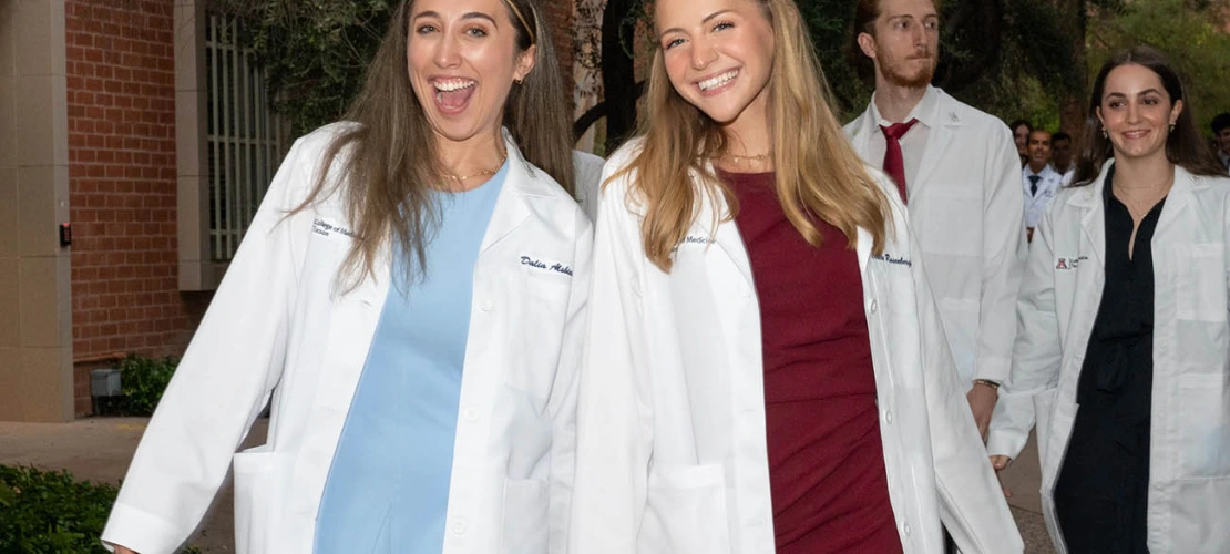 Dalia Alsbiei and Claire Rosenberger are all smiles as they leave Centennial Hall after the UArizona College of Medicine – Tucson Class of 2026 white coat ceremony.
