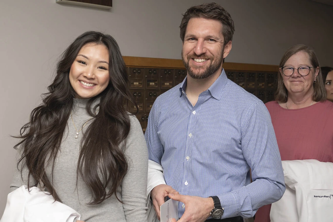 Julie Tran-Commisso, John Tredici and Victoria Kretche-Kitchel prepare for the College of Nursing’s DNP white coat ceremony.