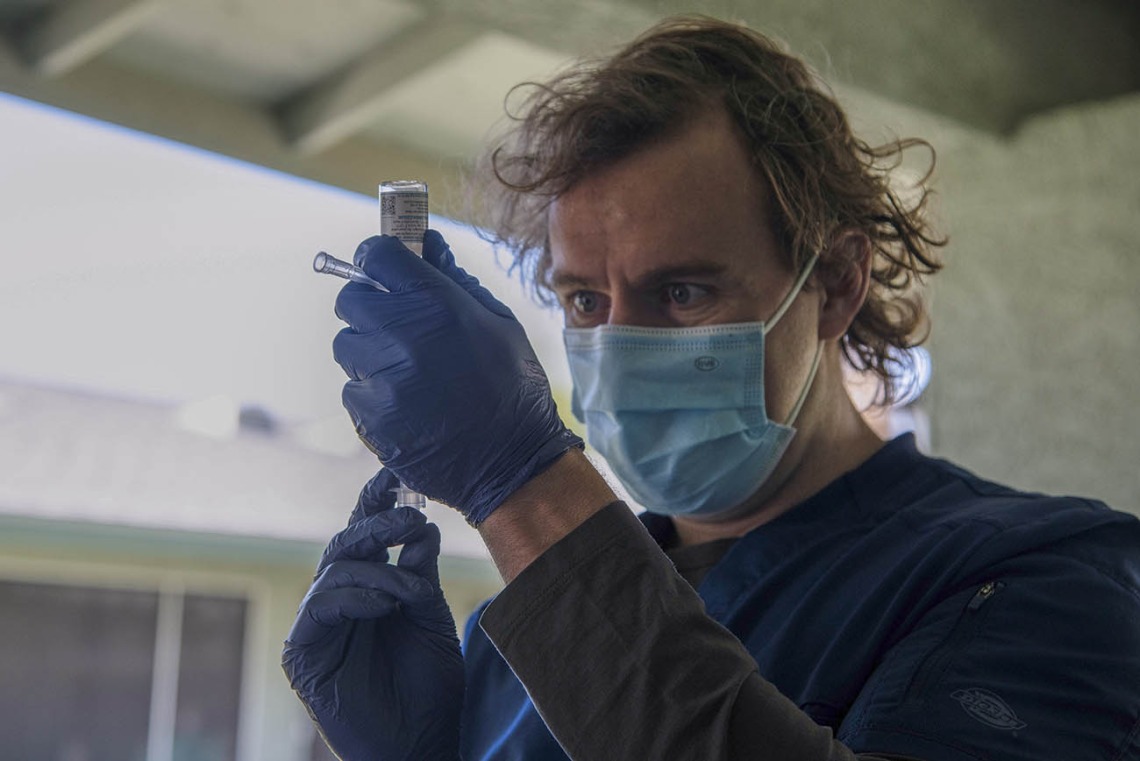 First-year College of Medicine – Phoenix student Colton Cowan preps a COVID-19 vaccine.