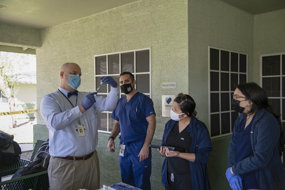 Dr. Jim Lindgren, director of simulation curriculum and clinical assistant professor at College of Medicine in Phoenix, trains medical and pharmacy students to administer the COVID-19 vaccine.