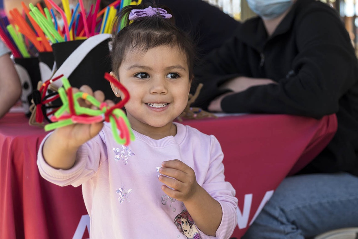 Ariyani Perez shows off a spider she made during the recent Family SciFest at Children's Museum Tucson.