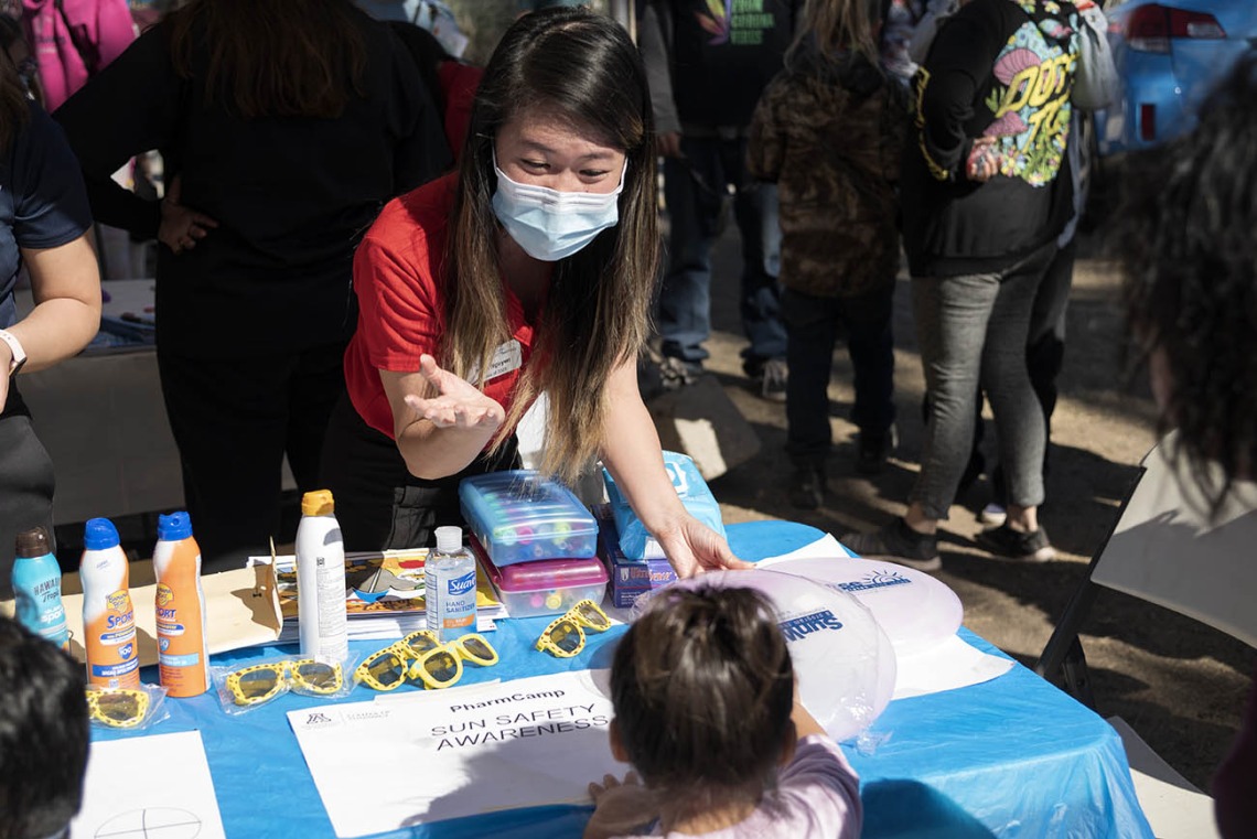 University of Arizona R. Ken Coit College of Pharmacy student Trinh Nguyen teaches children about sun safety during the recent Family SciFest at Children's Museum Tucson.