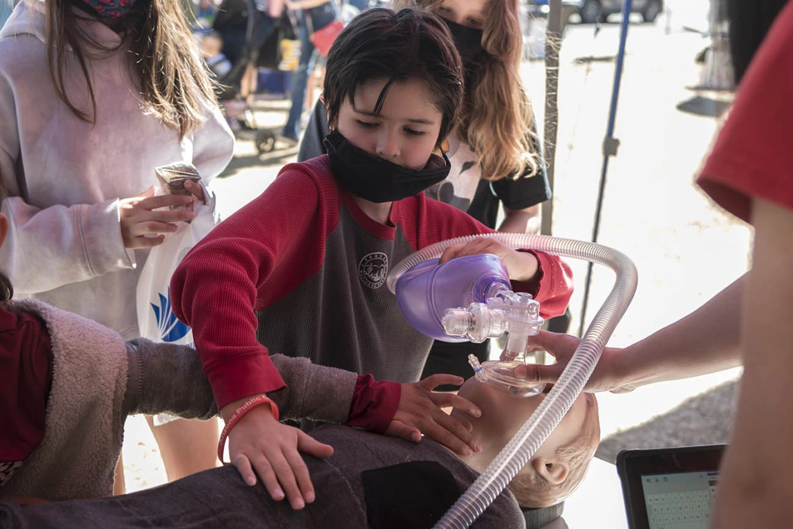 Evander McCauley uses a bag-valve-mask on a Hal, a child-size manikin, at a hands-on display by the Arizona Simulation Technology & Education Center (ASTEC) during the recent Family SciFest at Children's Museum Tucson.