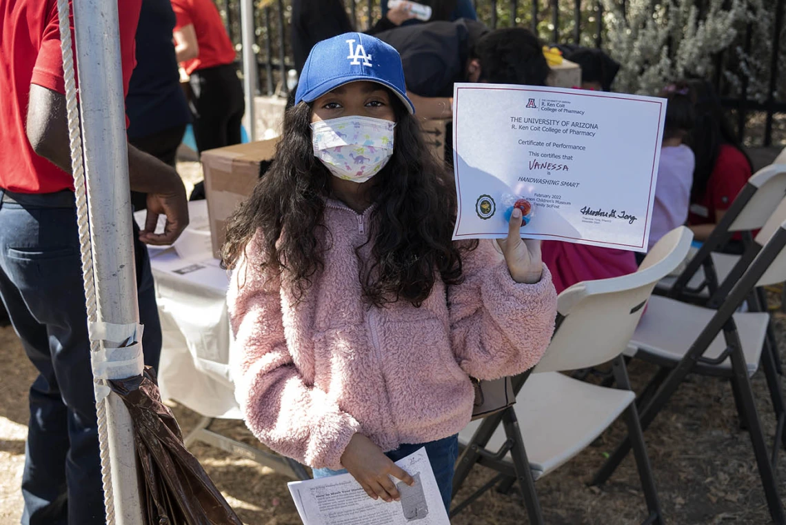 Vanessa Rendon holds up a certificate after completing an activity during the recent Family SciFest at Children's Museum Tucson.