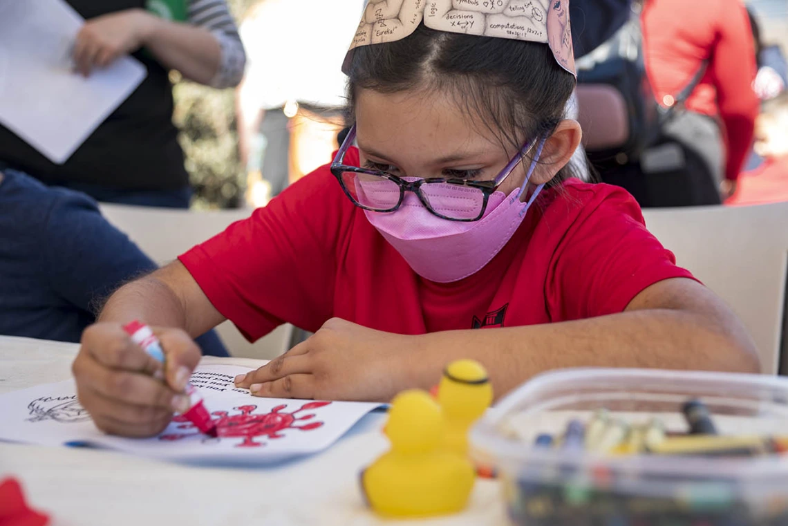 Emma Mendoza colors in a picture of a virus at the R. Ken Coit College of Pharmacy booth during the recent Family SciFest at Children's Museum Tucson. 