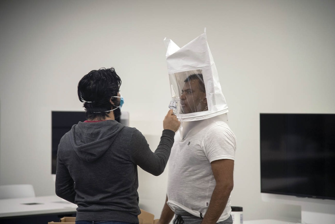 First-year College of Medicine – Tucson student Ahmed Al-Shamari sprays bitters into second-year medical student Waheed Asif’s hooded mask so he can identify their taste during subsequent tests in full protective equipment.