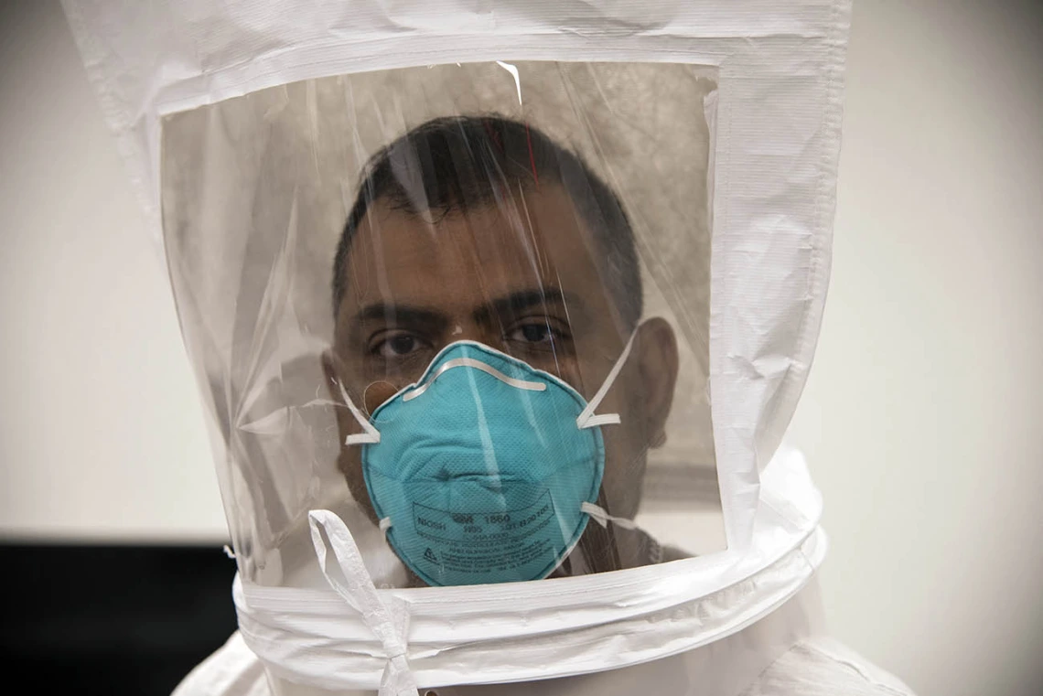 Second-year College of Medicine – Tucson student Waheed Asif wears an N95 mask under the hood, breathing normally to check for the taste of bitters. Then he will take deep breaths.