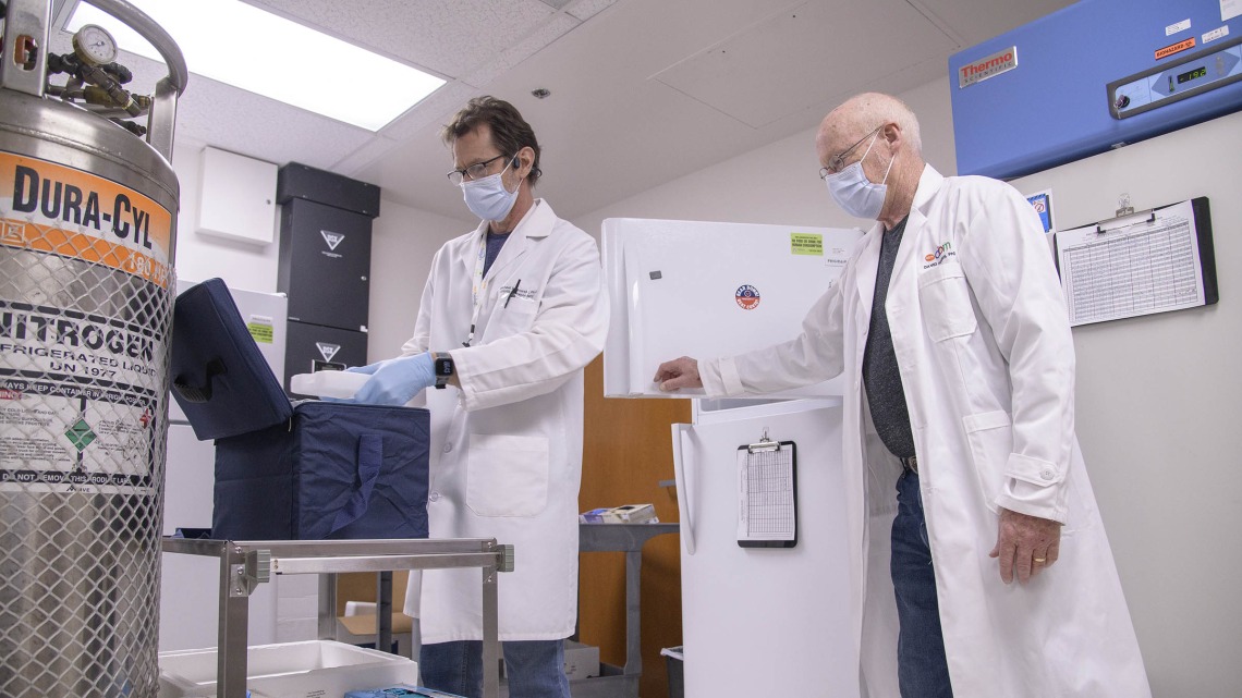 David Harris, PhD, executive director of the UArizona Health Sciences Biorepository (right), and Michael Badowski, PhD, associate research scientist in the Division of the Translational and Regenerative Medicine in the Department of Medicine at the College of Medicine – Tucson (left), are tasked with monitoring the “freezer farm.”