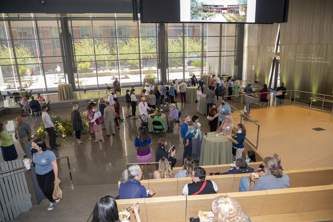 Attendees gather inside the University of Arizona Health Sciences Innovation Building for a reception after the groundbreaking for the Andrew Weil Center for Integrative Medicine.
