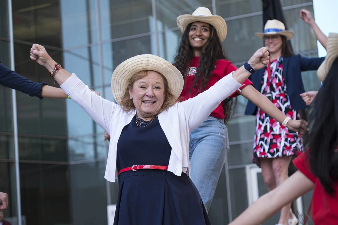 Kelly Lynch (center), alumni/student relations manager at College of Medicine – Phoenix, along with faculty, staff and medical students surprise the  class of 2022 with a dance before the start of the Match Day event.