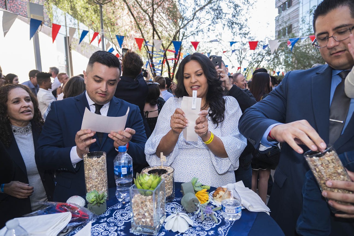 (From left) Jesus Sandoval, Valeria Vasquez and Jesus Leyva open their Match Day letters during the UArizona College of Medicine – Phoenix Match Day 2022 event.