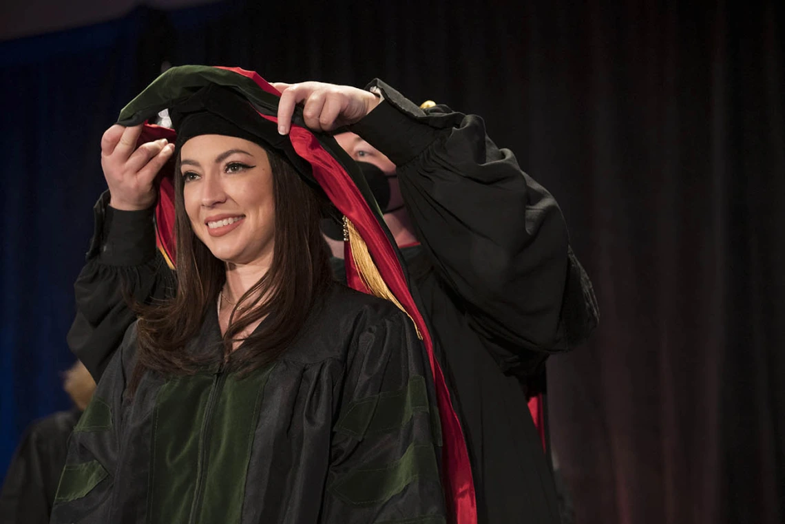 Danielle Arias, MD, is hooded during the College of Medicine – Phoenix class of 2022 commencement ceremony at the Phoenix Convention Center.