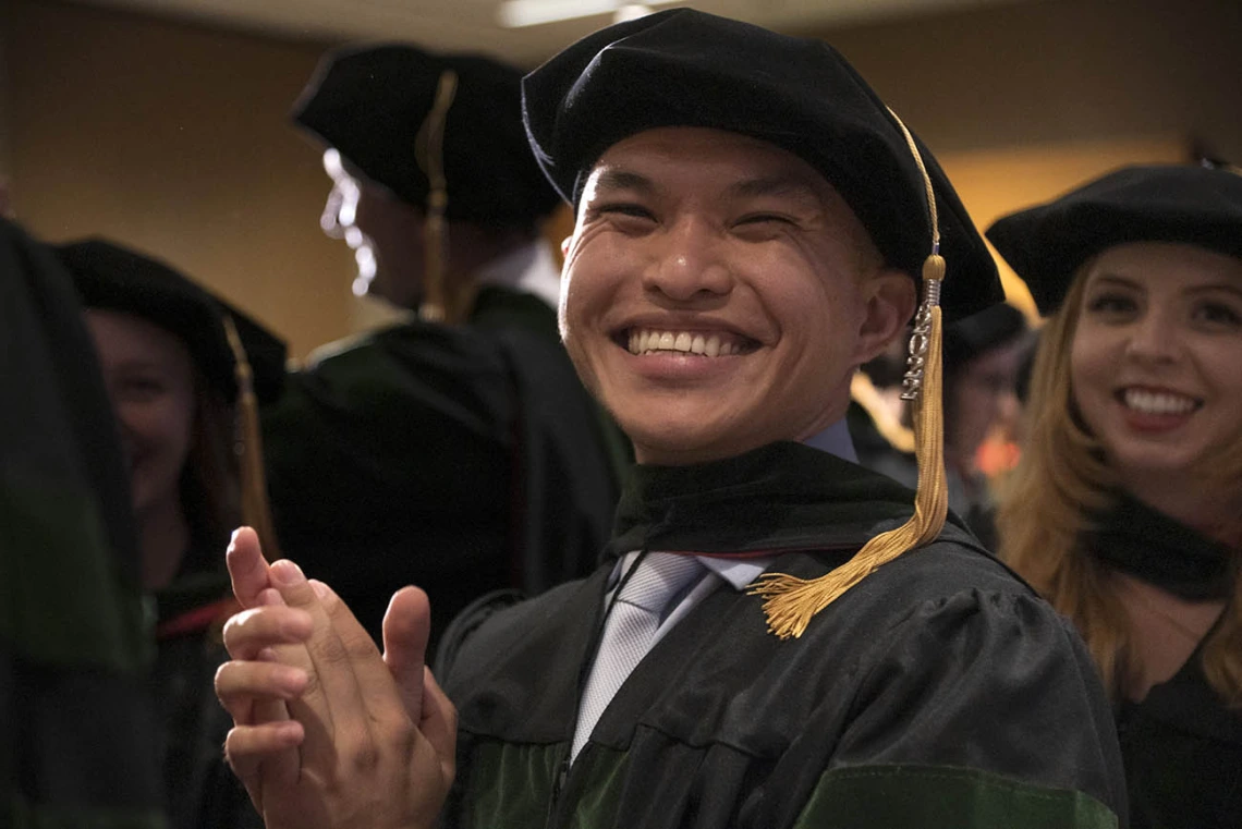 Allen Doan, MD, applauds a speaker during the College of Medicine – Phoenix class of 2022 commencement ceremony.